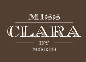 Miss Clara by Nobis hotel wordmark on a brown background